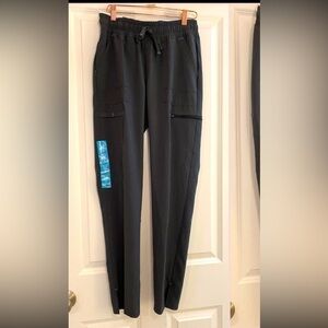 New with tags scrub star performance yoga pant in size xs. Pewter grey color